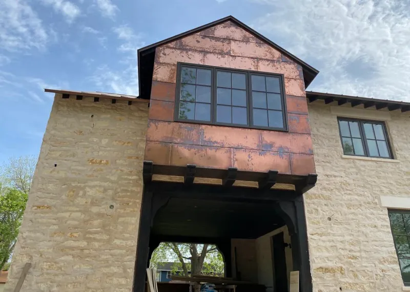 Copper metal panel facade on a stone building for Roof Repair in Wood Dale